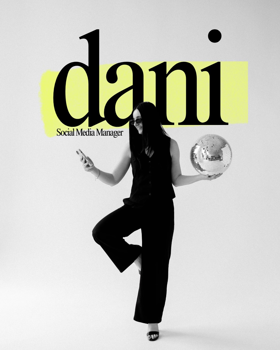 Dani, Social Media Manager, smiling at her phone while balancing a disco ball in one hand